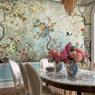 Chinoiserie birds and flowers wall mural in formal dining room with floral centerpiece and crystal chandelier