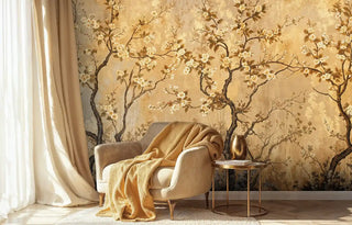 Chinoiserie blossom Wall Mural in gold showcased in cozy bedroom corner with cream armchair and throw blanket