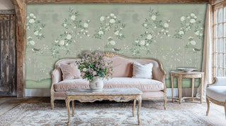 Chinoiserie floral wallpaper with birds shown in vintage living room with ornate pink sofa