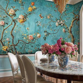 Chinoiserie garden wall mural with flowering branches and butterflies on turquoise, in elegant dining room with gold chandelier