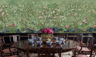 Chinoiserie garden wall mural with pink peonies and blue birds on sage green, in elegant dining room with mahogany table