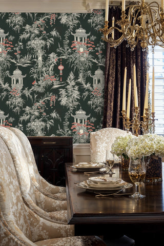 Chinoiserie pagoda wallpaper with lush botanicals and red lanterns, in elegant dining room with gold chandelier