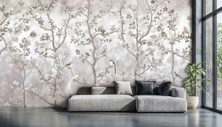 Chinoiserie wall mural of birds on branches in grey and beige, with big sofa and windows