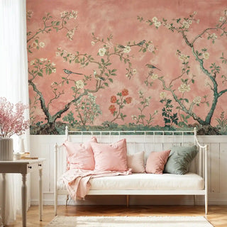 Chinoiserie wall mural with birds and flowering branches on coral background in cozy bedroom with white daybed
