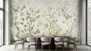 Chinoiserie wall mural with birds and trees in a dining room with a large wooden table and grey chairs.