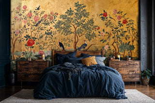 Chinoiserie wallpaper featuring exotic birds and blooming peonies on gold background, in bedroom with navy bedding