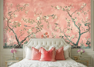 Chinoiserie wallpaper with delicate birds and blossoms in luxurious bedroom with tufted headboard