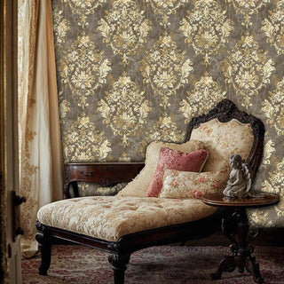 Classic damask pattern wallpaper in gold and grey adorning bedroom with ornate chaise lounge