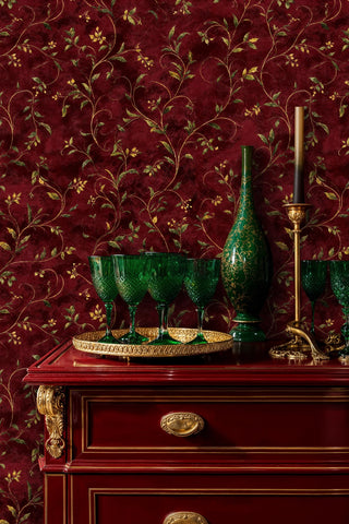 Classic leafy vine wallpaper in deep red tones, displayed in elegant room with ornate wooden console table