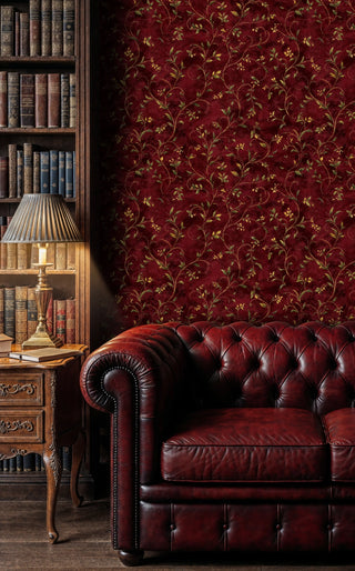 Classic vine wallpaper with golden botanical scrollwork on burgundy, shown in traditional study with leather chair