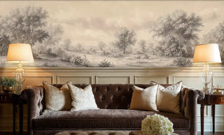 Classical landscape wall mural with rolling hills and trees, shown in sophisticated living room with brown velvet sofa