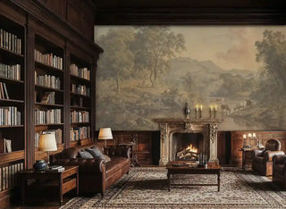 Classical pastoral wall mural depicting river valley with cattle and ancient trees, displayed in sophisticated library with leather furniture and ornate fireplace