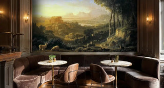 Classical pastoral wall mural featuring ancient temple, grazing sheep, and golden landscape, shown in elegant dining room with velvet banquette