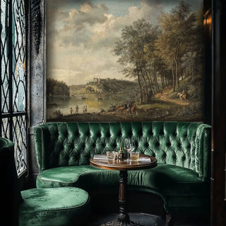 Classical riverside wall mural with period figures and castle, displayed in elegant green banquette seating