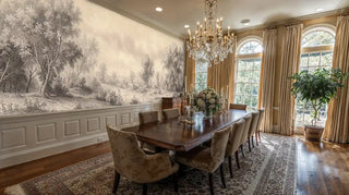 Classical scenic wall mural in ivory and brown tones with tree silhouettes, shown in formal dining room with chandelier