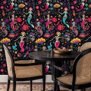 Colorful Day of the Dead mermaid wallpaper with floral details, displayed in modern dining room with cane back chairs