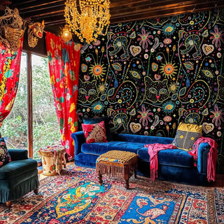 Colorful mystical wallpaper featuring cosmic dots and celestial symbols, shown in boho living room with crystal chandelier