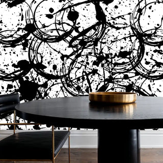 Contemporary abstract wall mural with bold black brushstrokes, shown in dining room with round black table