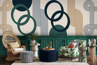 Contemporary circle pattern Wall Mural in navy and green tones, displayed in maximalist living room with wicker chair