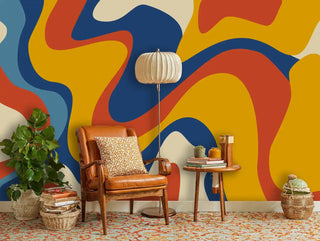 contemporary flowing shapes wallpaper in blue and orange tones, displayed in reading nook with leather armchair