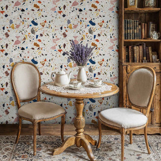 Contemporary terrazzo stone wallpaper with vibrant fragments, shown in elegant dining room with vintage round table