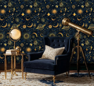 Cosmic pattern wallpaper with golden celestial bodies shown in elegant study with navy armchair and telescope