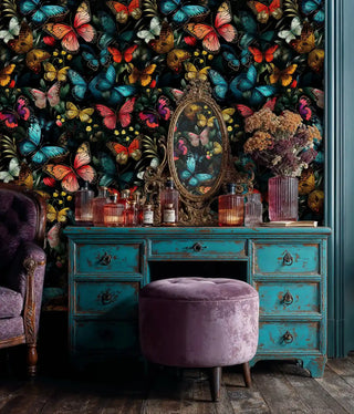 Dark botanical butterfly wallpaper with tropical butterflies shown in vintage bedroom with distressed turquoise dresser