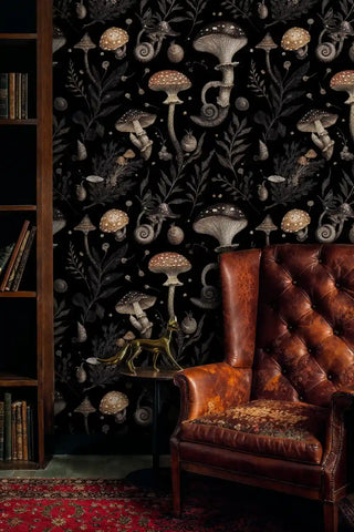 Dark botanical mushroom wallpaper in sophisticated study setting with leather wingback chair and oriental rug