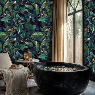Dark botanical orchid wallpaper with emerald leaves and golden centers on navy, in spa bathroom with marble tub