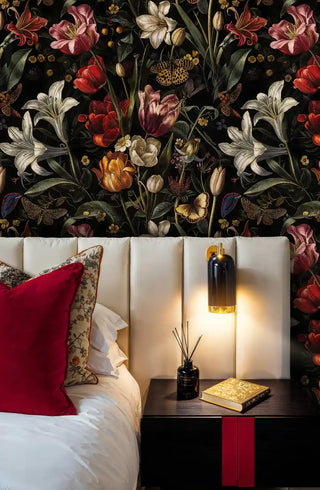 Dark botanical tulip wallpaper with butterflies, displayed in elegant bedroom with cream headboard