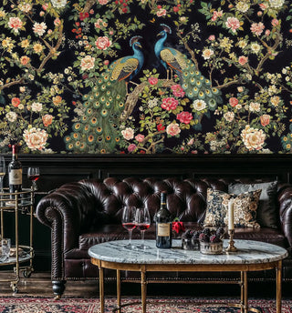 Dark botanical wall mural featuring peacocks among roses, displayed in luxury lounge with marble coffee table