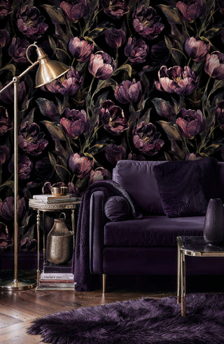 Dark botanical wallpaper displaying rich purple tulips in refined living room with purple velvet armchair