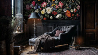 Dark botanical wallpaper featuring detailed flowers in moody study room with tufted chaise lounge and brass lamp