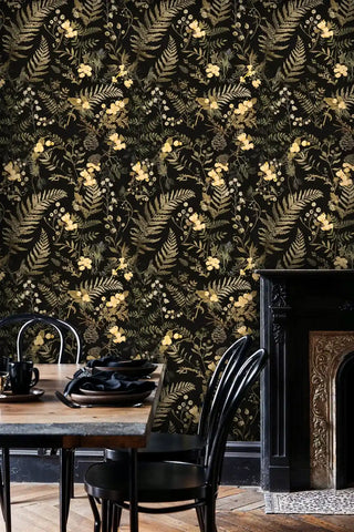 Dark botanical wallpaper featuring golden wildflowers, shown in cozy dining room with wooden table