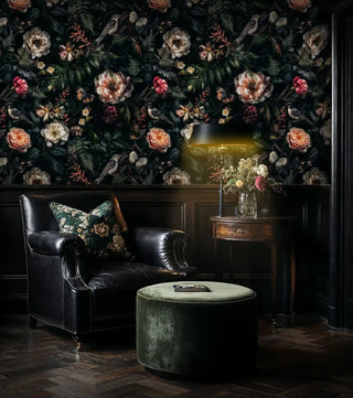 Dark botanical wallpaper with birds and ferns shown in sophisticated living room with leather sofa