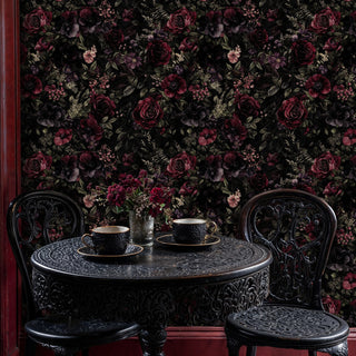 Dark botanical wallpaper with burgundy roses, displayed in charming dining nook with ornate table