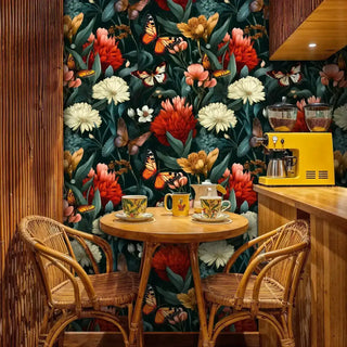 Dark botanical wallpaper with butterflies in a cozy coffee corner featuring rattan chairs and a bright yellow espresso machine.