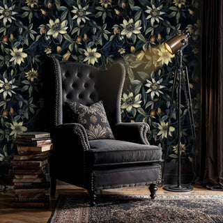 Dark botanical wallpaper with climbing clematis pattern, shown in sophisticated study with leather wingback chair