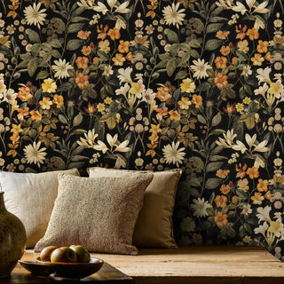 Dark botanical wallpaper with cream and orange flowers, shown in rustic living space with natural wood bench