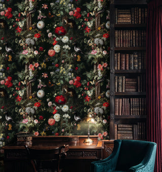 Dark botanical wallpaper with lush blooms and songbirds, shown in a study with antique bookcase and teal chair