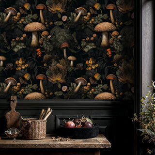 Dark botanical wallpaper with mushrooms and forest elements shown in rustic kitchen with wooden cutting boards