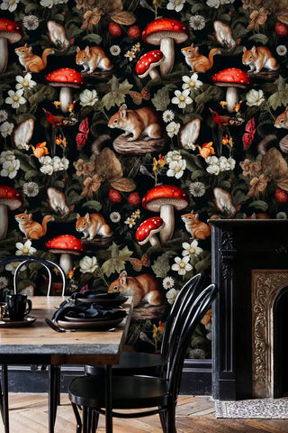 Dark botanical wallpaper with mushrooms and squirrels, styled in sophisticated dining room with black chairs