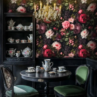 Dark botanical wallpaper with peonies in a classic dining nook featuring a crystal chandelier and a black cabinet with a tea set.