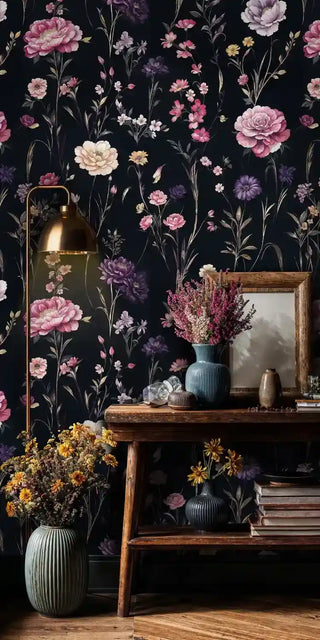 Dark botanical wallpaper with scattered wildflowers, shown in rustic living space with wooden console table