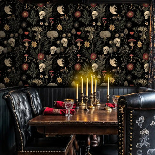 Dark botanical wallpaper with skulls and flowers displayed in elegant dining room with brass candlesticks