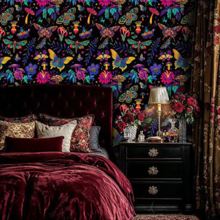 Dark butterfly wallpaper with jewel-toned moths and mushrooms, featured in luxurious bedroom with velvet headboard