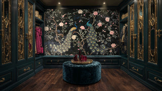 Dark chinoiserie wall mural with peacocks and pink peonies on black, in a luxe dressing room with velvet ottoman
