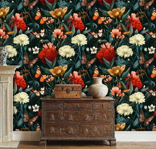 Dark floral and butterfly wallpaper in a vintage-style room featuring an ornate wooden dresser next to a classic fireplace.