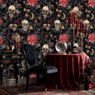 Dark floral skull wallpaper in moody dining room with crystal ball, red candles and black ornate chair