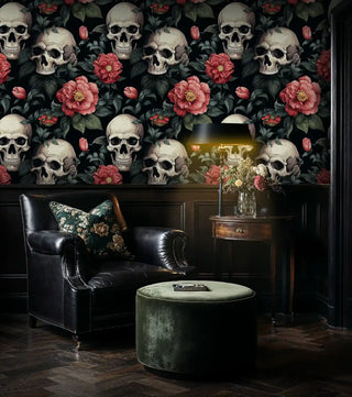 Dark floral skull wallpaper with red blooms, shown in sophisticated living room with green velvet ottoman
